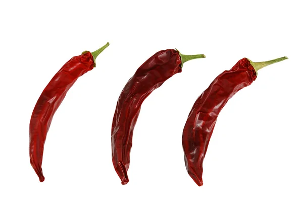 stock image Three dried hot red chili peppers isolated on white