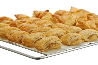 Baking grid with fresh baked bourekas clipart