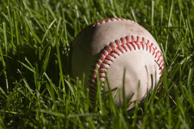 Baseball left on the field after a night game clipart