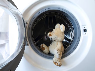 Toy mouse in a washing machine clipart