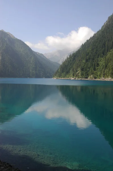 stock image Reflection of hills and trees in tranquil, blue Long Lake, Jiuzhaigou, China
