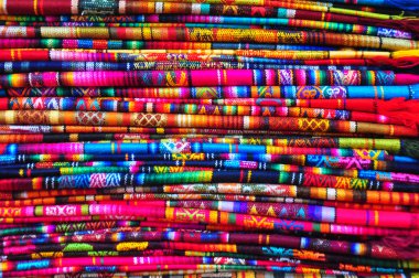 Brightly coloured textiles in craft market, Ecuador clipart
