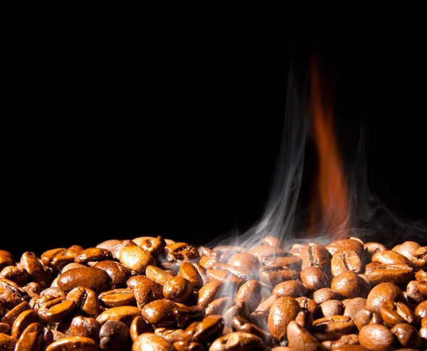 煙が黒の背景で香り豊かなコーヒー穀物 — ストック写真