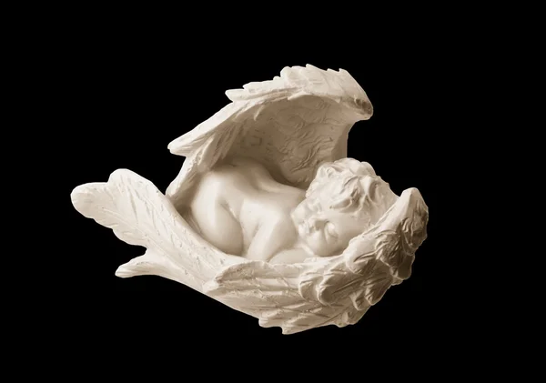 Stock image Figurine of the white angel it is sweet sleeping in wings