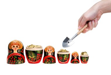 Three Matryoshkas full of coins and hand holding shovel clipart