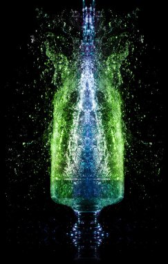 Liquid falling down into the glass with splashes at the black background clipart