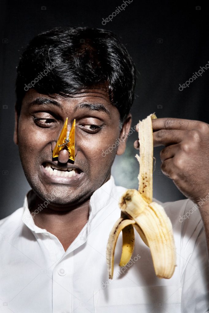 Indian man holding rotten banana — Stock Photo © byheaven #5129796