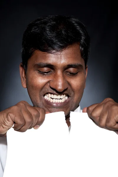 Indian man tearing paper sheet — Stock Photo, Image