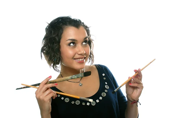Pretty girl with paint brushes — Stock Photo, Image