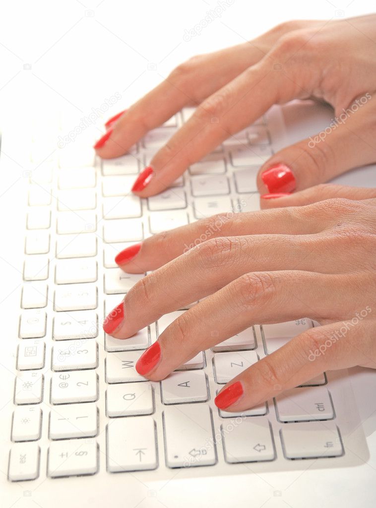 Woman hands on keyboard of white laptop