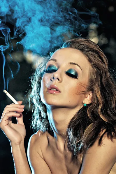 stock image Sexy girl smoking cigarette in the night club