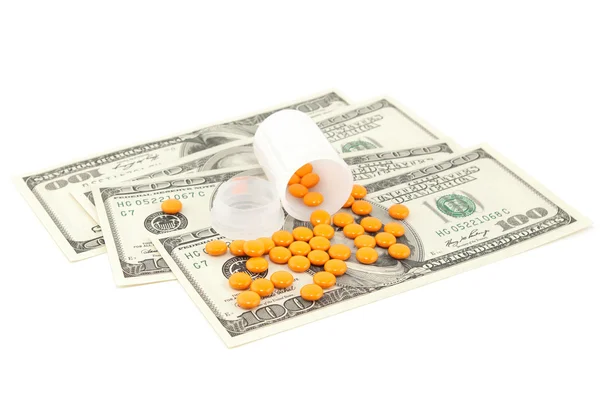 Orange piller på pengar, isolerad på vit bakgrund — Stockfoto