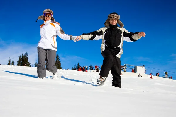 Los Esquiadores Felices Corren Sobre Nieve Imagen De Stock