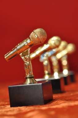 Golden microphones on red background clipart