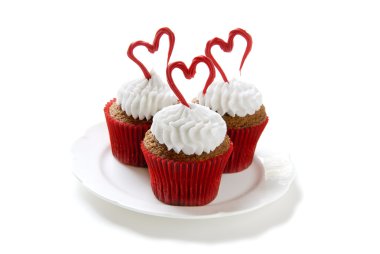 Cupcakes for Valentine's day. Chocolate cupcakes with vanilla frosting. Hearts made of red colored white chocolate. clipart
