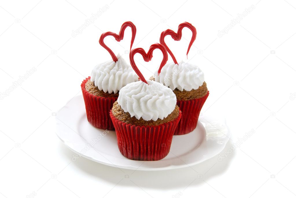 Cupcakes for Valentine's day. Chocolate cupcakes with vanilla frosting. Hearts made of red colored white chocolate.
