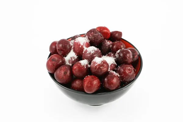 stock image Red cherry with sugar in black bowl