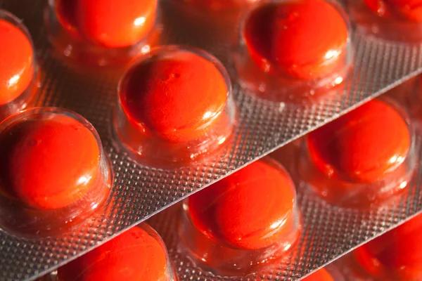 Red drugs on packed — Stock Photo, Image