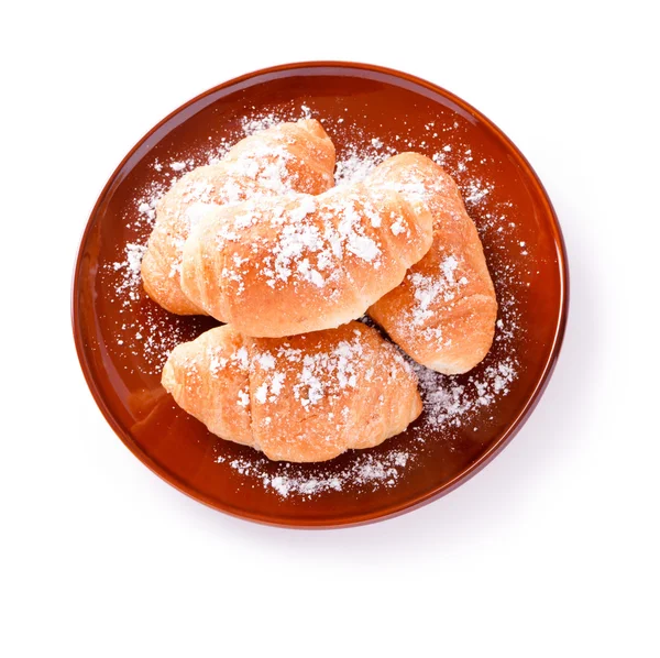 Croissants auf einem braunen Teller — Stockfoto