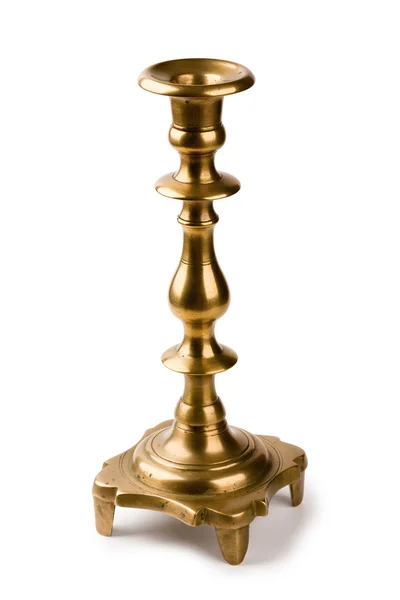 Antico candeliere in ottone finemente modellato per una candela isolata su un bianco Immagini Stock Royalty Free