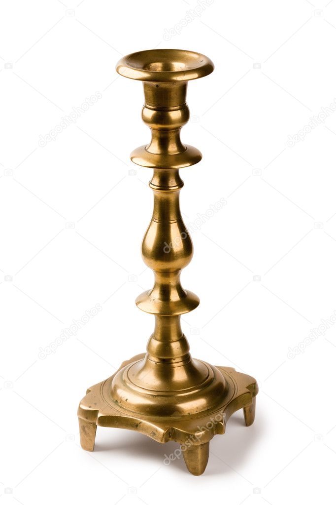 Ancient fine-molded brass candlestick for one candle isolated on a white