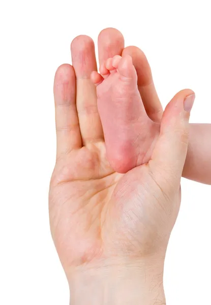 Small leg of the newborn baby girl in the big hand of the father, isolated — Stock Photo, Image
