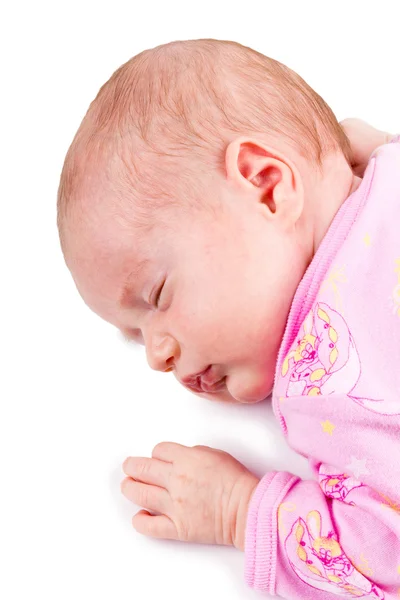 Portret van de slapende pasgeboren babymeisje in p! NK, geïsoleerd op een witte bac Rechtenvrije Stockafbeeldingen