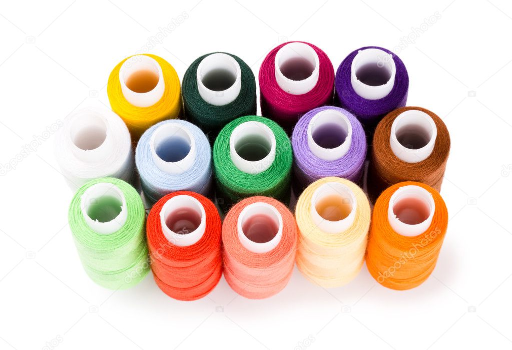 Spools multi-colored threads standing group isolated on a white background