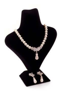 Pearl necklace on black stand clipart