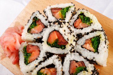 Sushi rolls with tuna and green onion top view clipart