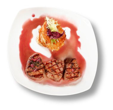 Veal Medallions with potato pancakes. Closeup. File includes clipping path for easy background removing clipart
