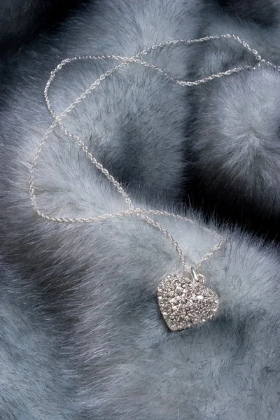 Chain with heart on fur — Stock Photo, Image