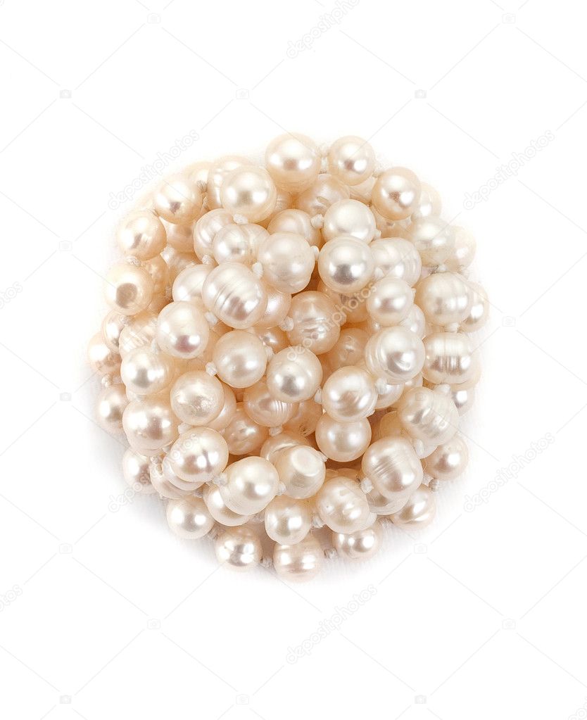 Reeled up pearl necklace on white background top view