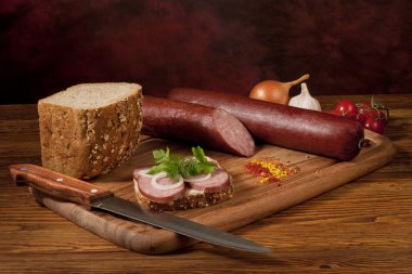 Composition with sausage on the table clipart
