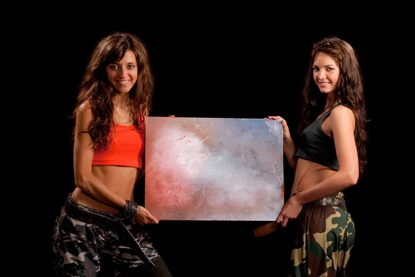 Image of a two girls holding a table — Stock Photo, Image