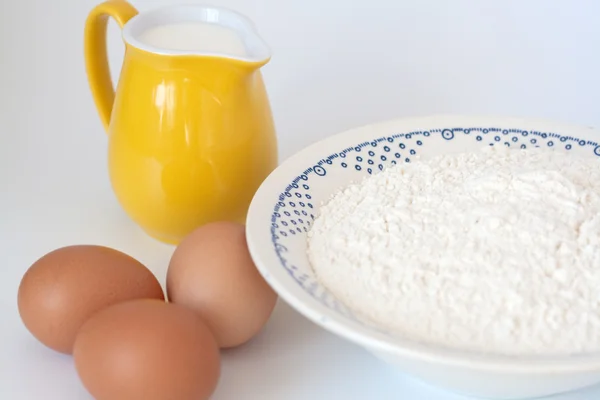 stock image Pitcher of milk, eggs and flour on a white background