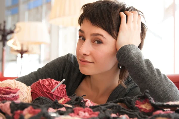 Portrait of a young beautiful girl with knitting — Stock Photo, Image