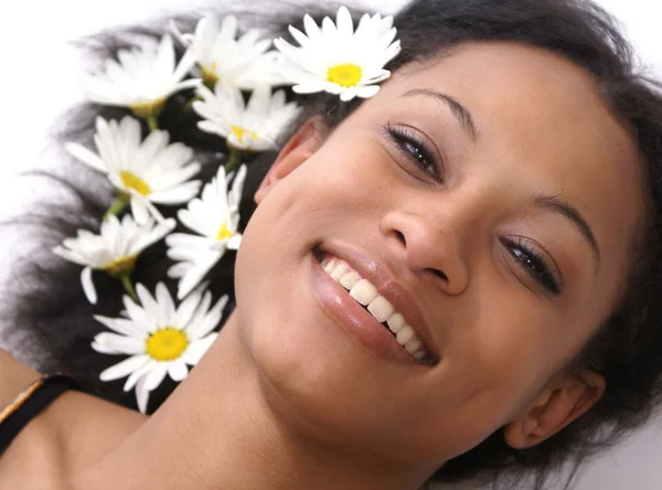 stock image Beautiful young female with daisies in her hair - perfect for spa and wellness concepts.