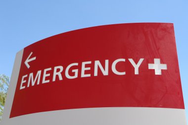 Bright red emergency sign directs patients where to go. clipart