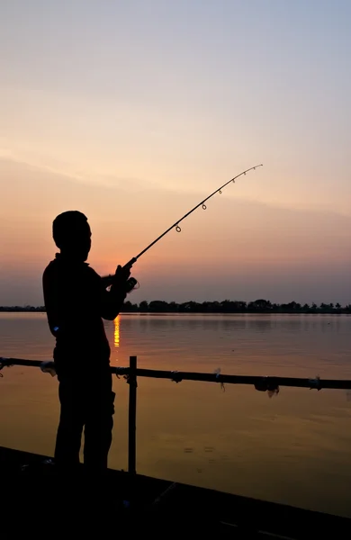 Silhouette of a man fishing — Stock Photo, Image