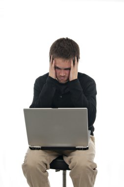 Frustrated teenager looking at laptop clipart
