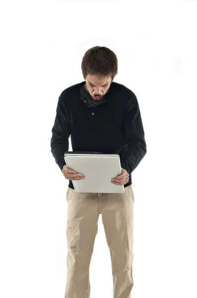 Злой подросток держит ноутбук — стоковое фото