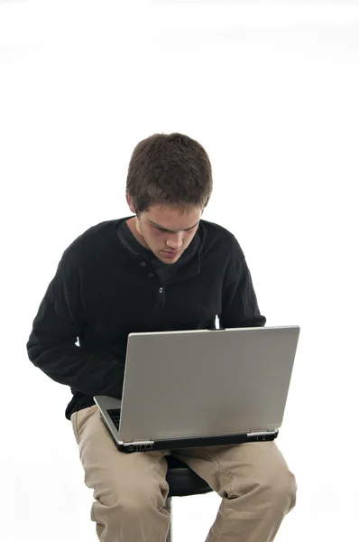 Teenage Boy Sitting Stool Looking Laptop White Background — Stock Photo, Image