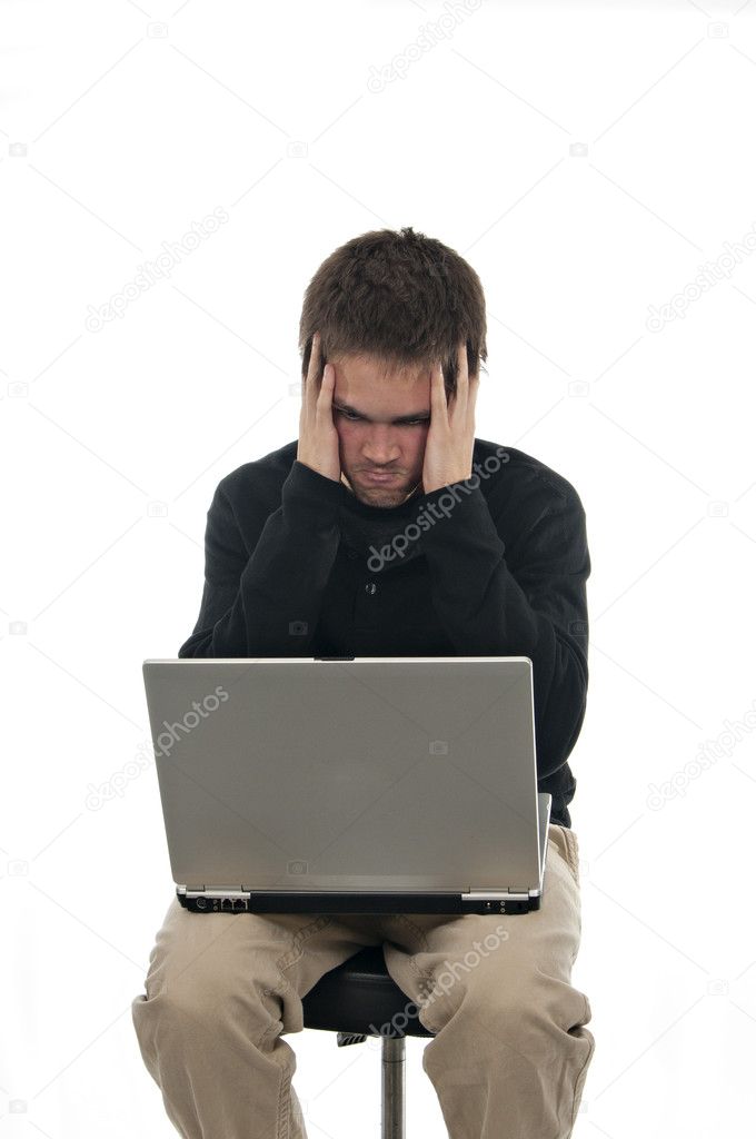 Frustrated teenager looking at laptop
