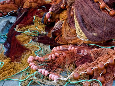 Fishing nets laid on the dock waiting to be repaired clipart