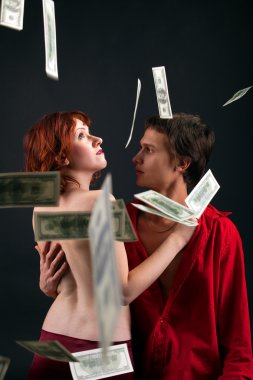 Young man and woman under money fall clipart