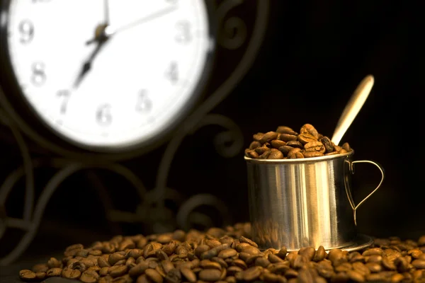 Steel cup of coffee and clock — Stock Photo, Image