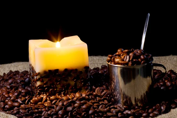 Cup wtih coffee bean and candle — Stock Photo, Image