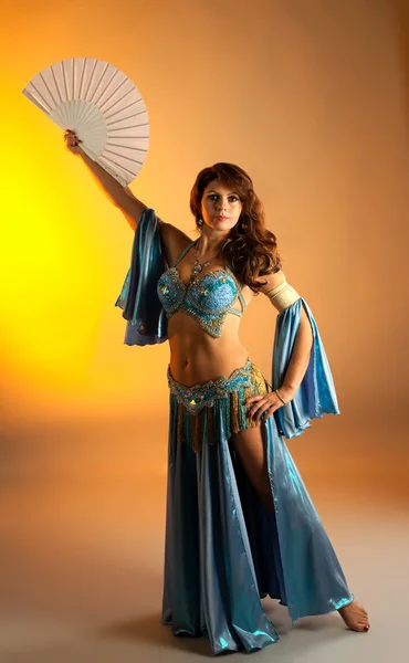 Mature woman in belly dance with fan — Stock Photo, Image