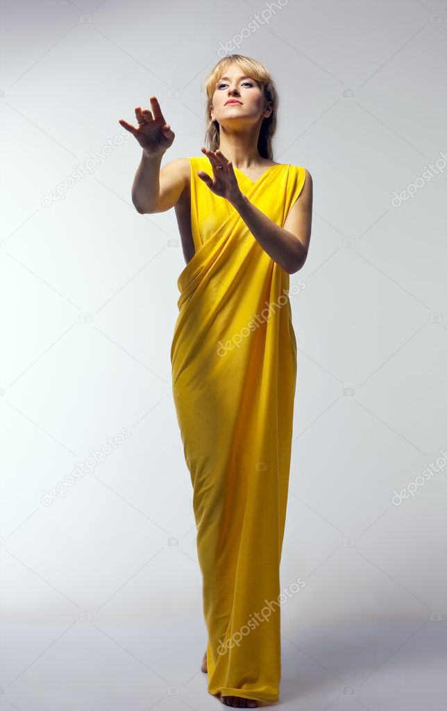Blond woman in yellow veil play role